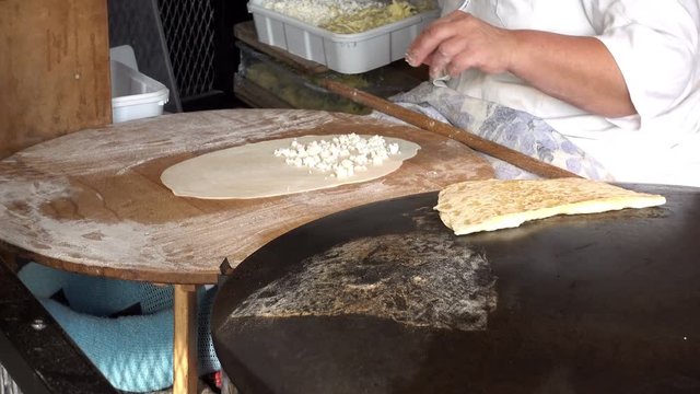 4K view of cook puts the filling on the dough. Istanbul street food.