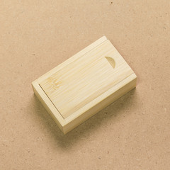 Small wooden box on brown texture background. Template of wood packaging made from bamboo material.