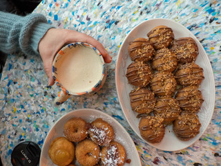 Drinking tea and eating donuts overhead shot