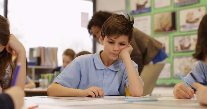 4k, Overworked and bored young student sitting in classroom. Slow motion.