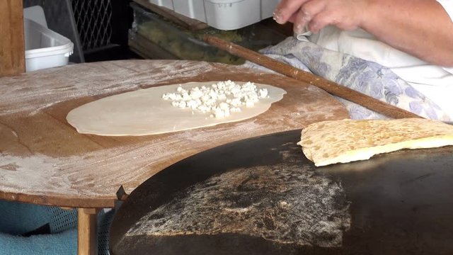 Cook puts the filling on the dough. Istanbul street food. HD video clip