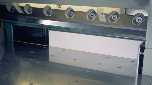 4K Industrial cutter for cutting paper shears. Guillotine machine at printing factory.