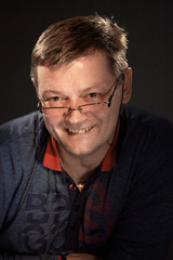 portrait of a man in the studio on a dark background.