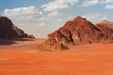 Red mountains of the canyon of Wadi Rum desert in Jordan. Wadi Rum also known as The Valley of the Moon is a valley cut into the sandstone and granite rock in southern Jordan to the east of Aqaba.