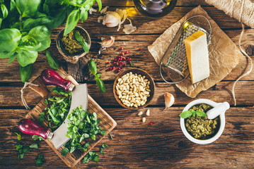 Pesto sauce and ingredients on old wooden table, vintage style