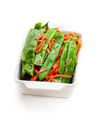 Green  string beans and carrot with spices isolated on white