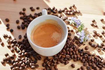 Coffee cup and coffee beans on wooden background. Top view.