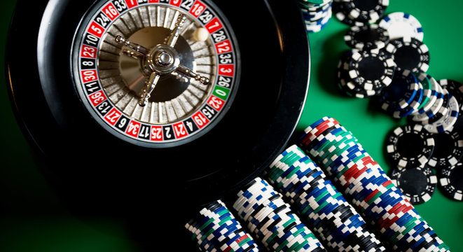 High contrast image of casino roulette and poker chips