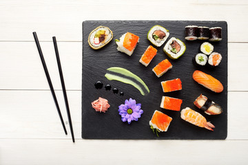 Sushi on black stone plate isolated top view