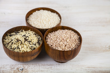 Obraz na płótnie Canvas Three bowls with different varieties of rice