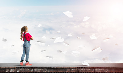 Concept of careless happy childhood with girl looking far away