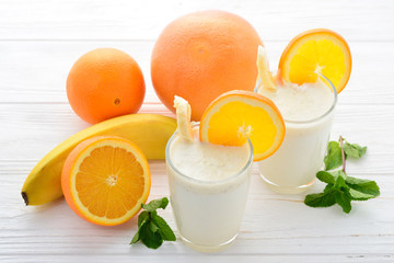 Ice cream with caramel and popcorn on a white table.