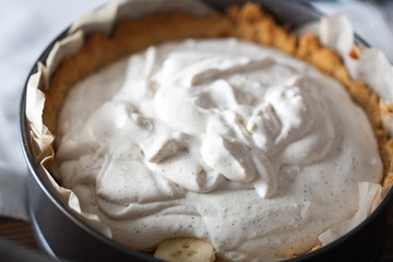 Moody Banoffee pie closeup with cream and bananas