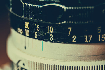 Old manual control lens body. Scratches and dirt. Close-up on the numbers of aperture ring. Retro...