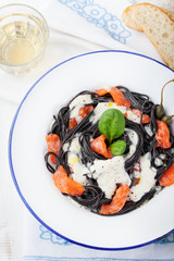 Black pasta spaghetti, cream sauce, smoked salmon