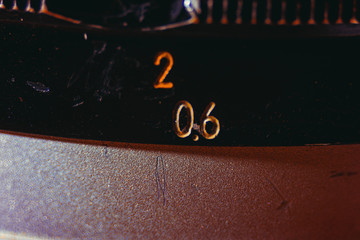 Old manual control lens body. Scratches and dirt. Close-up on the numbers of aperture ring. Concept of repair