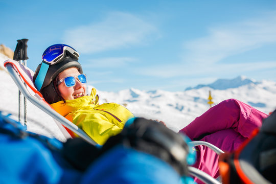 Image of smiling sports woman lying on winter deckchair