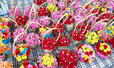 Colorful multicolored small artificial rose flowers in a basket