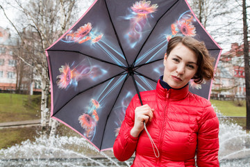Girl with umbrella outdoor in a rain day
