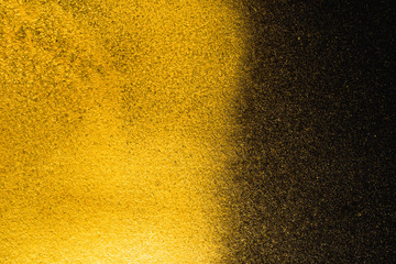 Golden abstract grainy texture on black background