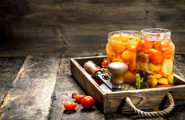 Marinated tomatoes with spices in an old tray.