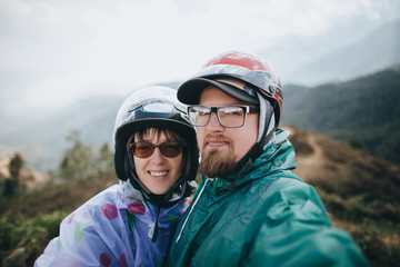 young couple of travelers looking at camera in Sa Pa, Vietnam