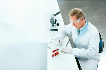Laboratory Test. Male Doctor Analyzing Blood Sample