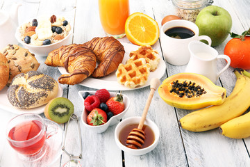 Breakfast served with coffee, orange juice, croissants and fruits. Balanced diet.