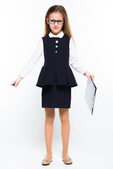 Little girl with pen and clipboard in her hands dressed as a businesswoman