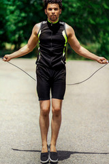A man in a sport suit jumping rope