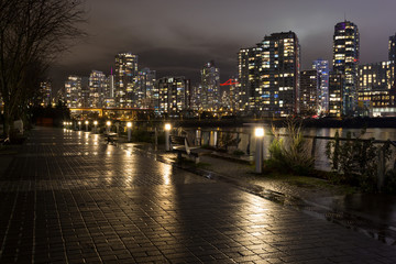 Fototapeta na wymiar Night Downtown City view during a rainy winter day. Taken in False Creek, Vancouver, British Columbia, Canada.