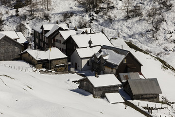 Old traditional village in winter in the Meiental valley in central Switzerland