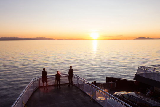 People on the ferry traveling from Vancouver to Vancouver Island, BC, Canada, are enjoying the beautiful summer sunset.