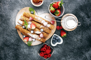 Delicious Tasty Homemade crepes or pancakes with raspberries and blueberries