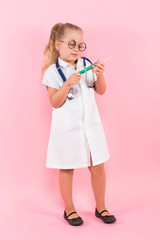 Little girl in doctor costume with injection