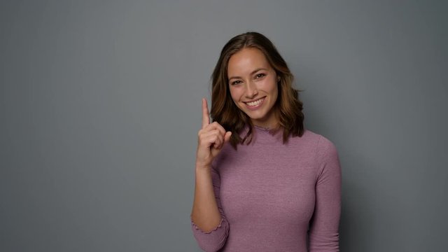 Smiling woman pointing