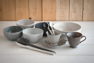 white bowl and spoon ceramic on a gray background