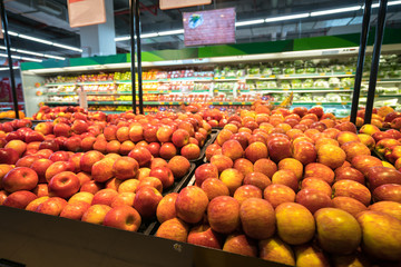 Fresh red apples on shelf in supermarket.