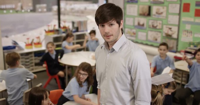 4k, Portrait of an unhappy class teacher while students wreak havoc in the background. Slow motion.
