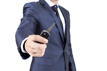 Businessman holding car key Isolated on white background.