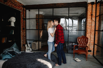 Obraz na płótnie Canvas stylish young couple having fun in cozy bedroom in style loft, feeling happy being together.