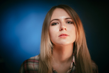 portrait smiling girl on blue background in studio