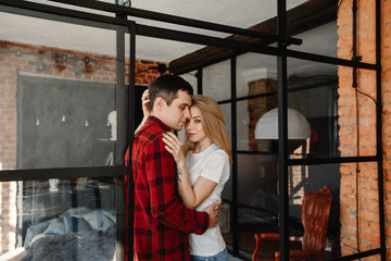 stylish young couple having fun in cozy bedroom in style loft,  feeling happy being together.