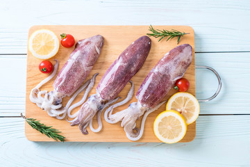 fresh octopus or squids raw on wooden board