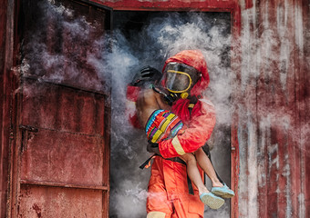 Fototapeta premium Emergency Fire Rescue training,Firefighters save the boy from burnt place