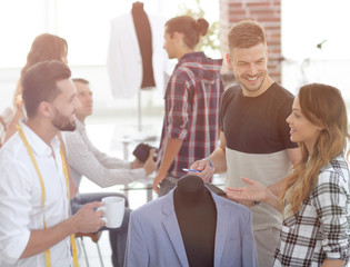 group of designers discuss men's suit