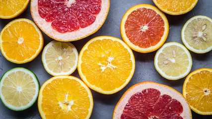 raw food: slicing citrus fruits. Orange, tangerine, lemon lime grapefruit
