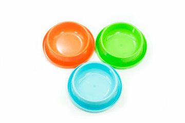 Pet accessories concept:  Bowl orange,green and blue for dog on isolated white.