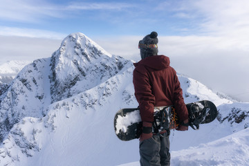 Fototapeta na wymiar Snowboarder riding Revelstoke Mountain, British Columbia, Canada.