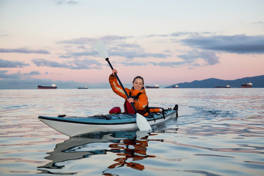 Sea Kayaking near Vancouver Downtown, British Columbia, Canada. Taken during a vibrant sunrise.